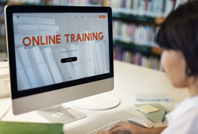 Image of women watching an online training course on her computer